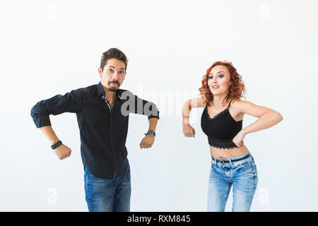 Social dance concept - Crazy dancing, cheerful couple over white background Stock Photo