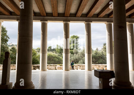 Athens, Greece – February 7, 2019: A man visit ancient site of Stoa Attalosa in Athens Agora. Stock Photo