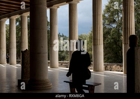 Athens, Greece – February 7, 2019: A man visit ancient site of Stoa Attalosa in Athens Agora. Stock Photo