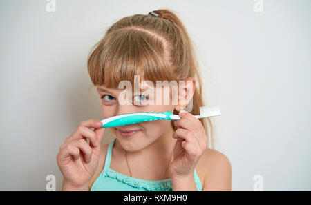 child puts the braces in the mouth Stock Photo