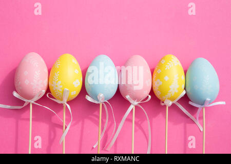 Colorful Easter eggs on pink background Stock Photo