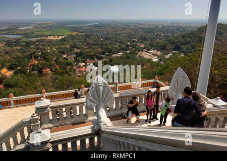 Cambodia, Phnom Penh, Oudong, visitors taking souvenir photograph on steps of Buddha’s eyebrow hair stupa Stock Photo