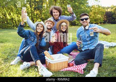 A group of young people having on a picnic in the park. Stock Photo
