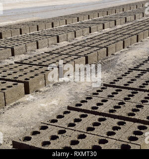 Cinder blocks lie on the ground and dried. on cinder block production plant Stock Photo