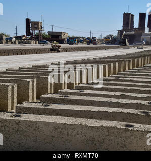 Cinder blocks lie on the ground and dried. on cinder block production plant Stock Photo