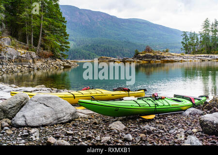 Two Kayaks along a shoreline in Desolation Sound, Sunshine Coast, British Columbia, Canada Stock Photo