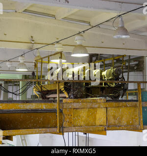 Engines that control the operation of the hoist. Lift motors on a steel frame under the ceiling. Stock Photo