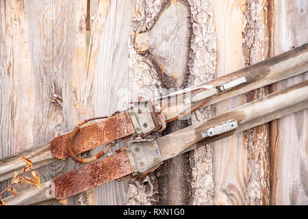 old rusty wooden cross-country skis on a wooden wall Stock Photo