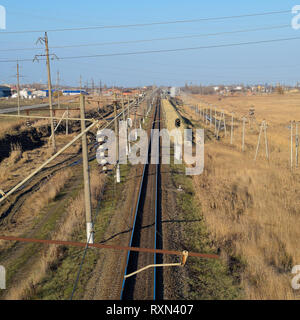 Plot railway. Top view on the rails. High-voltage power lines for electric trains. Stock Photo