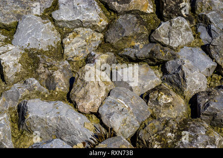 background pattern of diverse big rocks in different sizes and shapes, natural and decorative architecture Stock Photo