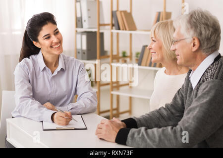 Senior couple planning investments with financial consultant Stock Photo