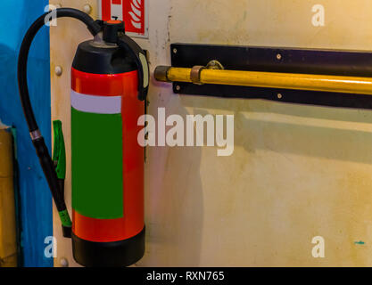 fire extinguisher hanging on a wall, fire prevention, safety equipment Stock Photo