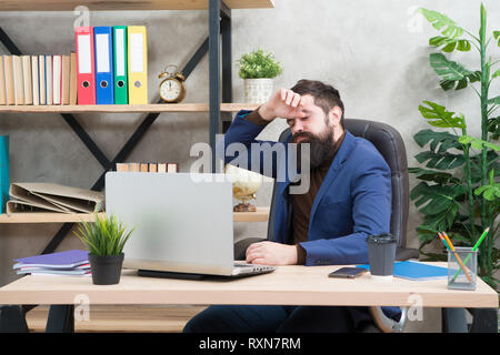 overwork. he needs help. tired businessman in formal outfit. Confident man use laptop and smartphone. Boss overworked workplace. Bearded man in business office. overwork concept. Feeling overworked. Stock Photo