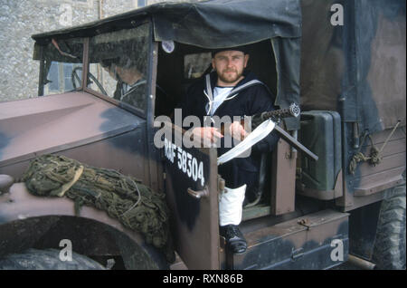 WW2 Sailor sat in Truck holding a machine Gun Stock Photo