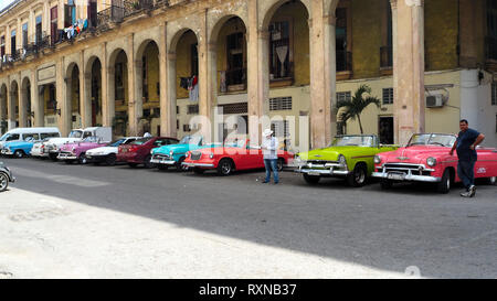 HAVANA, CUBA - February 2019: A series of vintage taxis waiting for tourists in Old Havana. Stock Photo