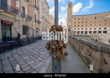 Lecce, Puglia, Italy -  Padlocks hanging on a street pole. Medieval street and historical center in the old town.  A region of Apulia Stock Photo