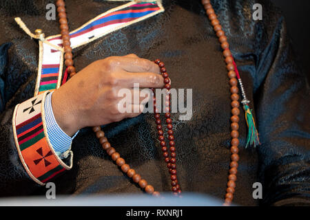 Tibetan monk bracelet on buddihst hand detail Stock Photo