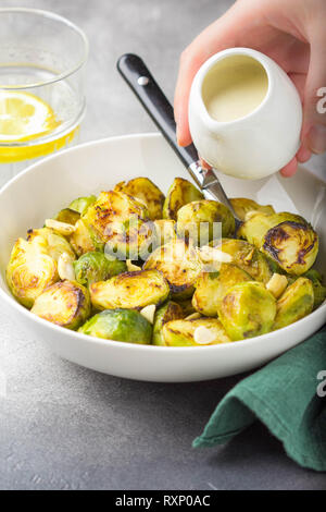 Delicious roasted Brussels sprouts and bacon in baking dish isolated on ...