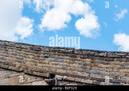 Sky clouds over stone fence Stock Photo