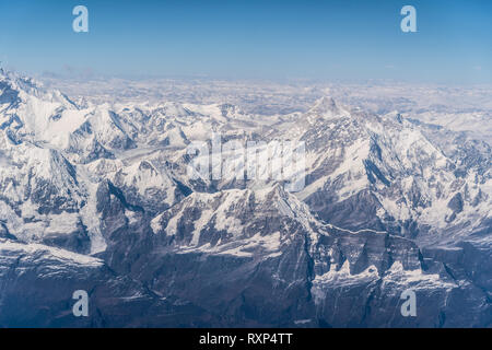 Aerial view of the snow capped Himalayas mountain in Nepal from a plane on a sunny winter day Stock Photo