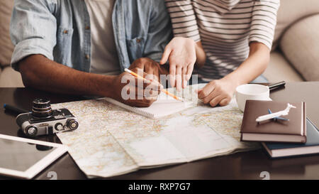 Couple planning vacation, making notes in diary Stock Photo