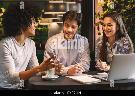 Young man sharing creative ideas with colleagues Stock Photo