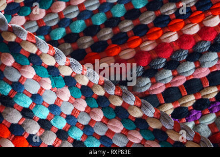Multicolored Motley Rag Woven Rug Background. Domestic Cozy Rug Patchwork Fabrics Stock Photo