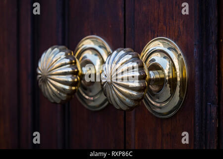 Copper door handles shot close-up against the door. Stock Photo