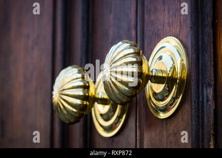 Copper door handles shot close-up against the door. Stock Photo