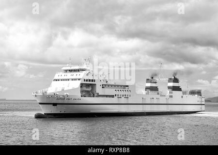 Port of spain, Trinidad and Tobago - November 28, 2015: modern ship vessel Super Fast Galicia floats in blue sea inshore on cloudy sky on seascape background Stock Photo