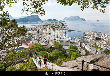 Family halfway up a path that leads from the Town Park to top of Mount Aksla and that offers panoramic views of the city of Alesund, Norway Stock Photo