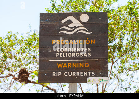 Playa Punta Islita,/ Costa Rica -January 28, 2019: rip currents warning sign in a Pacific Ocean coast, public beach Playa Punta Islita, Costa Rica Stock Photo