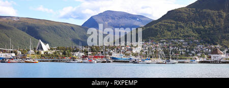 Eastern part of the city of Tromso on Kval Island. To the left is the Tromsdalen Church or more commonly referred to as the Arctic Cathedral because of its distinctive architecture. Tromso, Norway Stock Photo