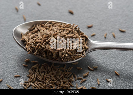 spoon caraway seeds of on table macro Stock Photo