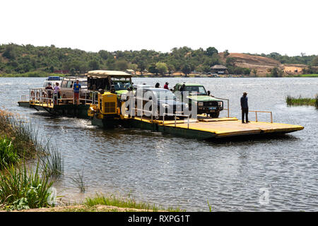 Ferry transporting vehicles and people across the Victoria Nile river at Paraa in Murchison Falls National Park, Northern Uganda, East Africa Stock Photo