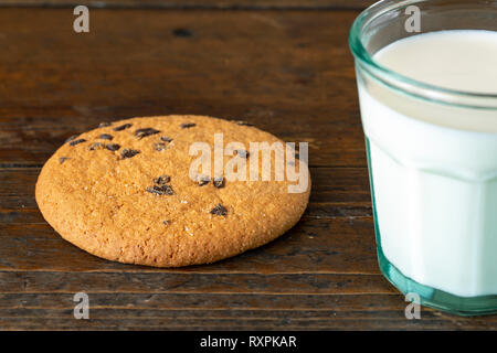 Pile of Delicious Chocolate Chip Cookies on a White Plate with Milk Bottles Stock Photo