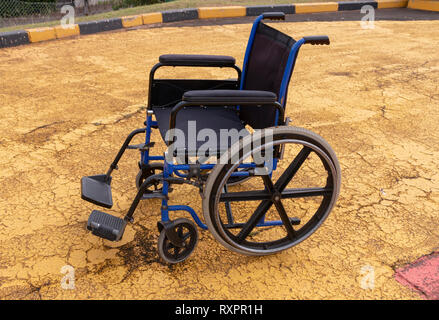 A close up side view of a hospital wheelchair that is on the helicopter landing area waiting for a patient to be brought to the hosprtail via a emergn