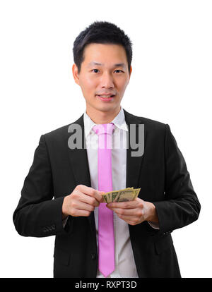 Asian business man in holding money in hand and looking at camera Stock Photo