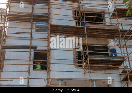 A close up view of a construction site where a new building is being constructed and they have put up rows and rows of scafolding Stock Photo