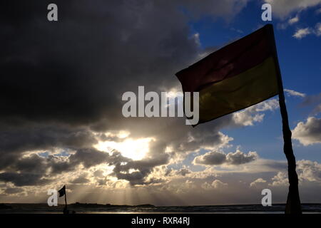 RNLI Flags Red and Yellow with dramatic sky Stock Photo