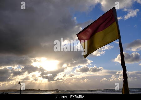 RNLI Flags Red and Yellow with dramatic sky Stock Photo