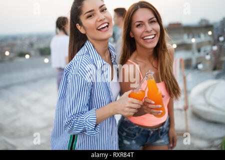 Friends having party on top of the roof. Fun, summer, city lifestyle and friendship concept Stock Photo