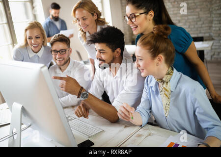Group of business professionals having a meeting. Diverse group of designers smiling at the office. Stock Photo