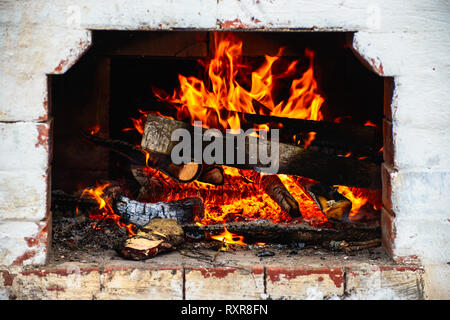 logs are burning in the stove Stock Photo