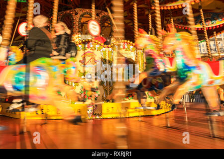 South Bank, London, UK. 10th Mar 2019. The colourful wooden horses and ornaments on a funfair carousel on the South Bank glow in the warm evening sunlight, following a day of sunshine and showers. Credit: Imageplotter/Alamy Live News Stock Photo