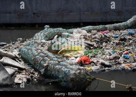 Cebu City, Philippines. 10th Mar 2019.  A barrier made of recycled plastic bottles encased in netting stretched across a river used to catch garbage which would otherwise float down into the Ocean.A recent report by NGO ( GAIA) (Global Alliance for Incinerator Alternatives) highlights the shocking use of single use plastic within the Philippines.Figures include some 60 billion single use sachets, 57 million shopping bags   an estimated 16.5 billion smaller plastic bags known as 'Labo' being used annually. Credit: imagegallery2/Alamy Live News Stock Photo