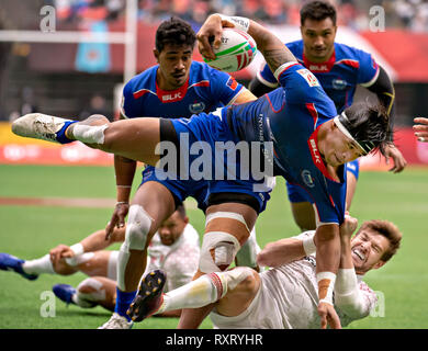 Vancouver, Canada. 10th Mar, 2019. Tofatu Solia (top, front) of Samoa and Tom Mitchell of England compete in the HSBC World Rugby Seven Series at BC Place in Vancouver, Canada, March 10, 2019. Credit: Andrew Soong/Xinhua/Alamy Live News Stock Photo