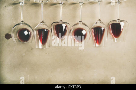 Red wine in different glasses over grey background, copy space Stock Photo