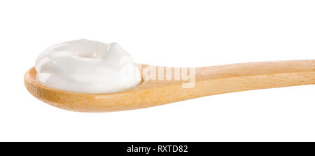 Sour cream in wooden spoon isolated on white background. Stock Photo