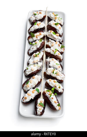Dates  stuffed with cream cheese and almonds isolated on white Stock Photo